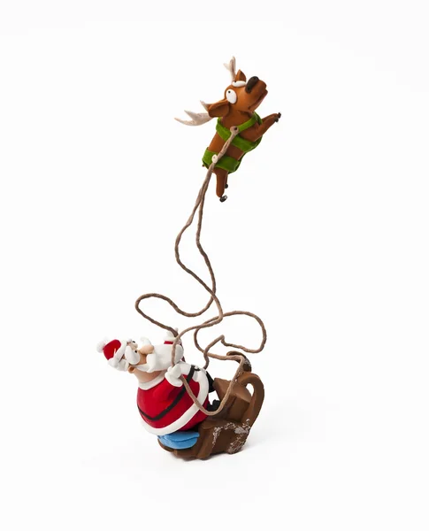 Papai Noel montando no trenó com uma rena — Fotografia de Stock