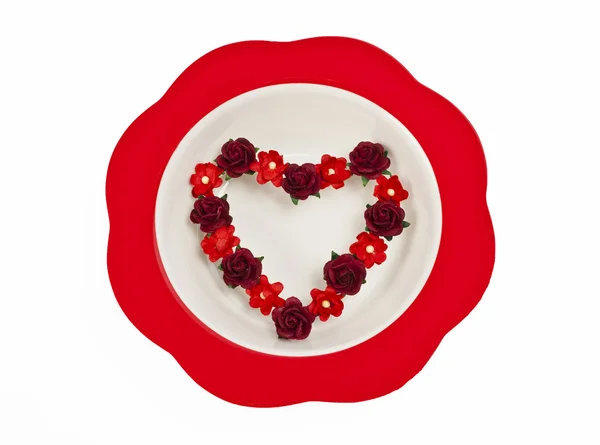 Flower heart symbol in red bowl — Stock Photo, Image
