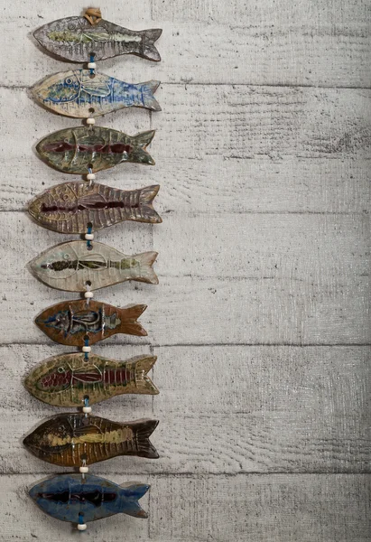 Ryby ceramiki powiesić na ścianie drewniane — Zdjęcie stockowe