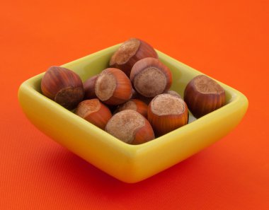 Group of hazelnuts in a bowl. clipart