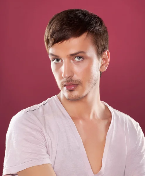 Young handsome man in a white shirt over red — Stock Photo, Image