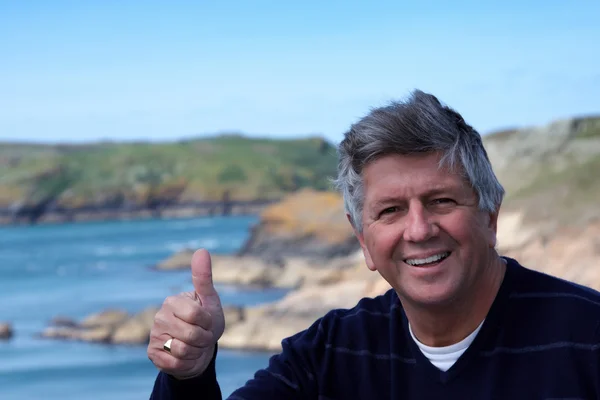 Mature man giving the thumbs up — Stock Photo, Image