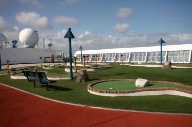 Crazy golf on the top deck of a ship clipart