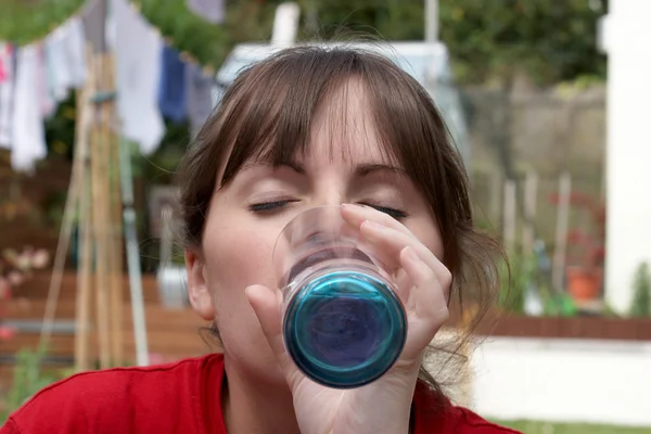 stock image A young female drinking a glass of water