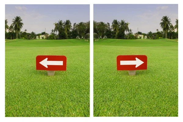 Біла стрілка в червоному лейблі на зеленій траві в гольф-клубі — стокове фото