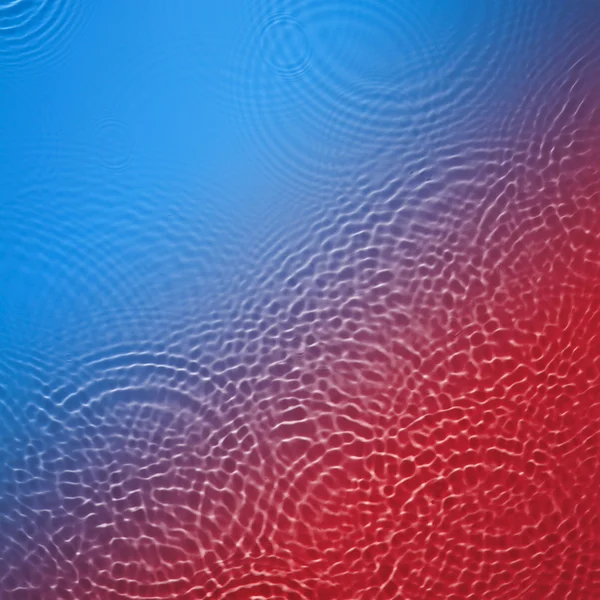 Azul e vermelho círculo água ondulação fundo — Fotografia de Stock