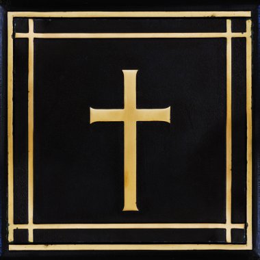 Golden cross, symbol of the Christian faith on the black backgro clipart