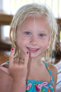 Beach Girl Using I love You Hand Gesture clipart