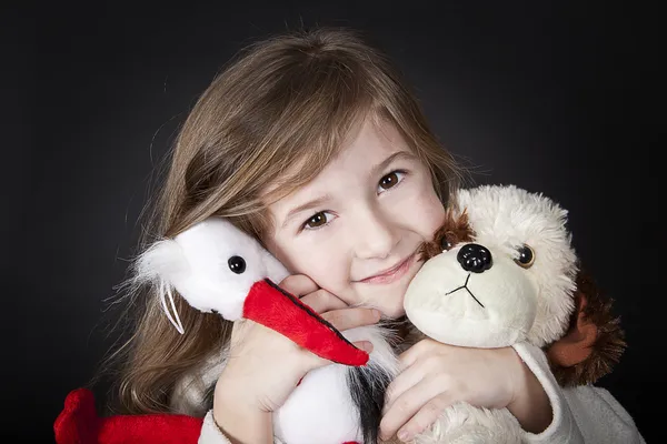 Happy girl with her toy friends — Stock Photo, Image