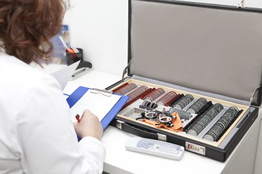 Optometrist preparing diagnosis clipart