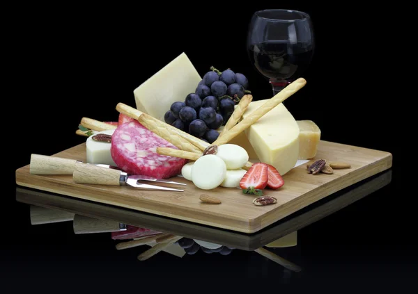Cheese platter with fruits and nuts — Stock Photo, Image