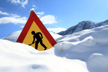 Under construction sign on snow clipart