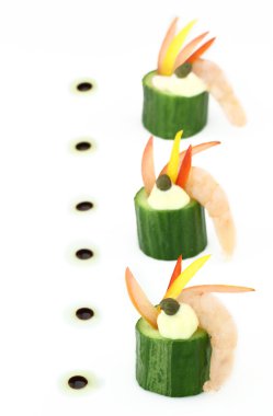 Finger food of cucumber stuffed with shrimp and peppers clipart