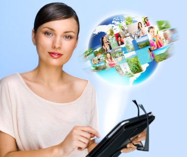 Portrait of young woman holding her tablet computer and communicating with her friends across the world. Standing against world map with photo of . International communications concept clipart