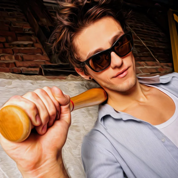 Portrait of young guy with bat leaning on the wall — Stock Photo, Image
