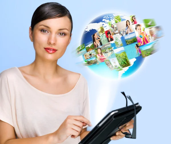 Portrait of young woman holding her tablet computer and communicating with her friends across the world. Standing against world map with photo of . International communications concept — Stock Photo, Image