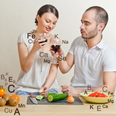 Young lovely couple cooking a balanced diet. Big copyspace. Vita clipart