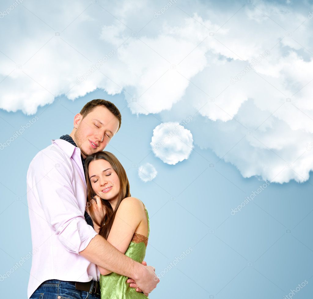 Portrait of young couple standing together and embracing
