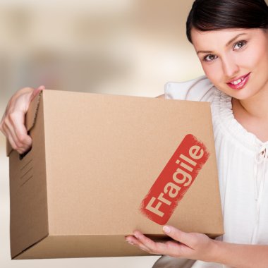 Closeup portrait of a young woman with boxes moving to her new h clipart