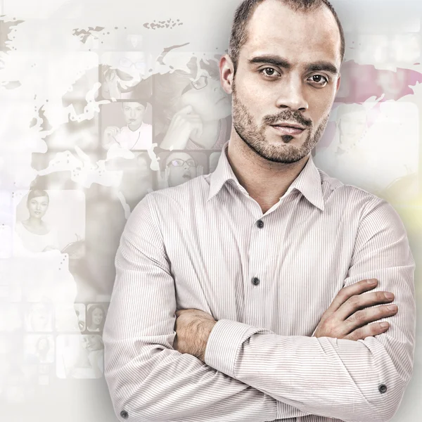 Portrait of young businessman. Standing against world map with p — Stock Photo, Image