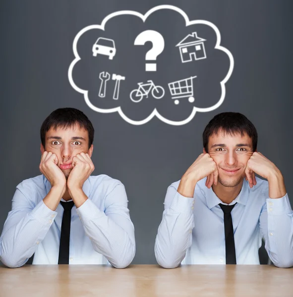 Image of two young similar men thinking of their plans sitting t — Stock Photo, Image