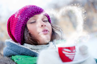 Young beautiful girl dreaming of love outdoors in winter while h clipart