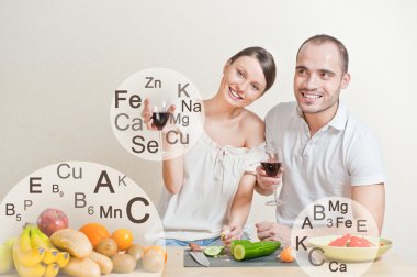 Young lovely couple cooking a balanced diet. Big copyspace. Vita clipart
