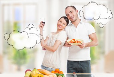 Lovely romantic couple in casuals enjoying a goodtime in kitchen clipart