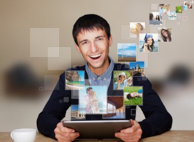 A technology man has images flying away from his modern tablet c clipart