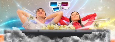 Close up of a cute couple watching movie on their home cinema st clipart