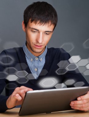 Closeup of a young smiling business man sitting at his office ag clipart