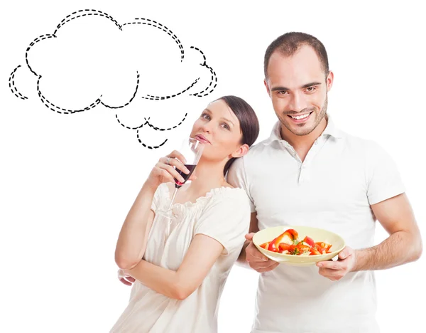 Junges hübsches Paar, das auf weißem Hintergrund eine ausgewogene Ernährung zubereitet — Stockfoto