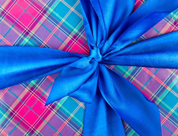 Big blue holiday bow on ornamental background — Stock Photo, Image