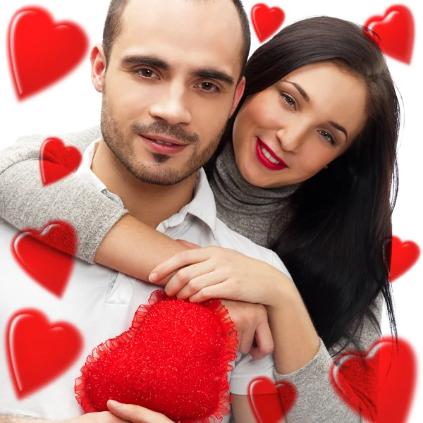 Beautiful young love couple embracing against a white background — Stock Photo, Image