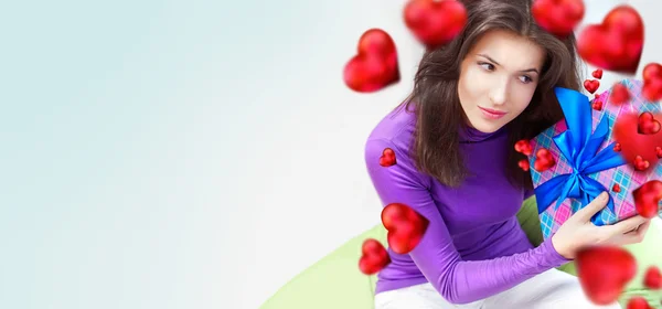 Delighted woman opening her gift — Stock Photo, Image