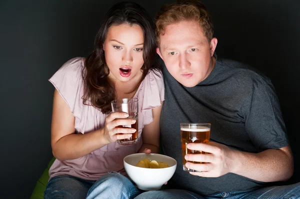 A couple watching a scary movie and it scared them so much that — Stock Photo, Image