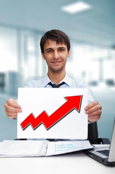 Attractive man in business suit with sign of up graph sitting at — Stock Photo, Image