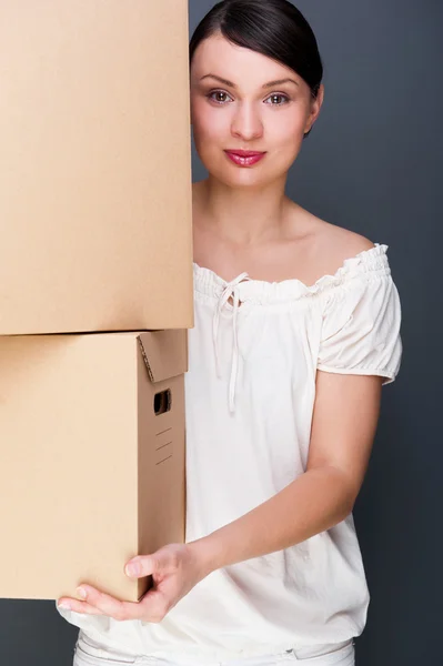 Closeup portrait of a young woman with boxes — Stock Photo, Image