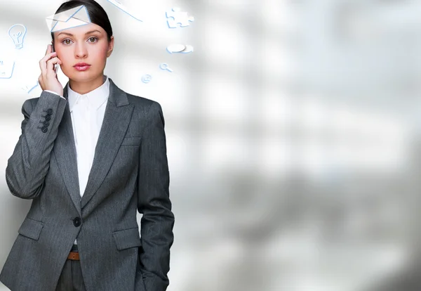A business woman with icons of her affairs flying around her he — Stock Photo, Image