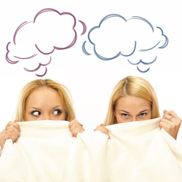 Two women in a bed hiding half of their faces and gossip. Blank — Stock Photo, Image