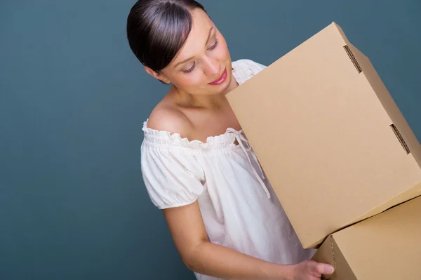 Closeup portrait of a young woman with boxes — Stock Photo, Image