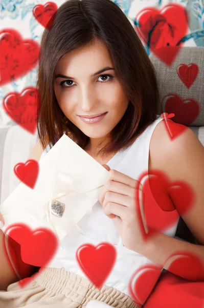 Portrait of young attractive happy woman, reading valentine card — Stock Photo, Image
