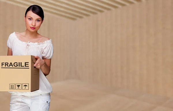 Closeup portrait of a young woman with boxes moving to her new h — Stock Photo, Image