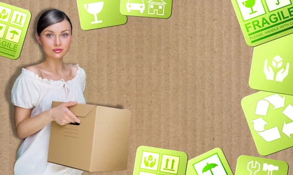 Closeup portrait of a young woman with boxes moving to her new h — Stock Photo, Image