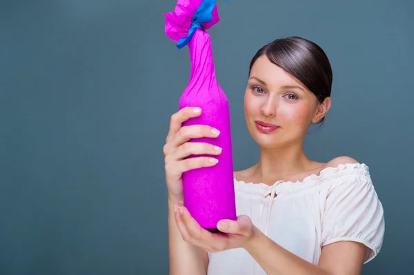 stock image Portrait of young pretty woman holding bottle of prefect wine in