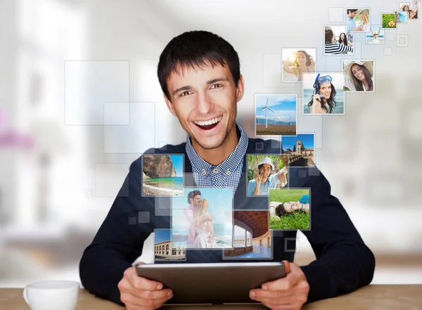 A technology man has images flying away from his modern tablet c — Stock Photo, Image