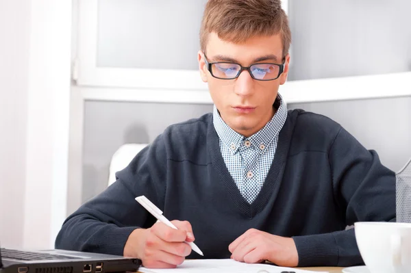 High school - Young male student write notes in classroom — Stock Photo, Image