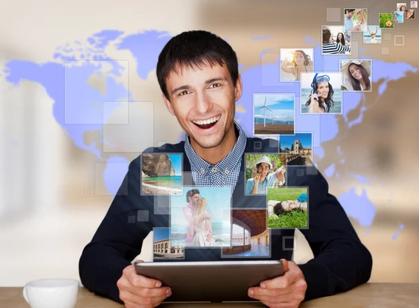 A technology man has images flying away from his modern tablet c — Stock Photo, Image