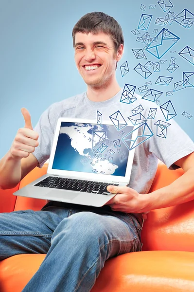 Portrait of handsome young man holding laptop computer and worki — Stock Photo, Image