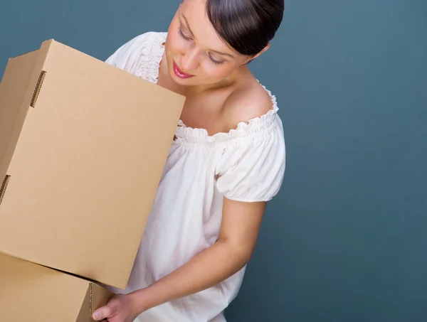 Closeup portrait of a young woman with boxes Royalty Free Stock Photos